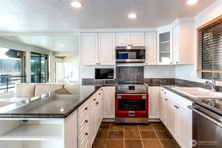 The chef's kitchen is anchored by a striking Italian Fulgor Milano professional range, creating a distinctive focal point for entertaining and everyday living. This is a new $9k appliance and a stainless steel door is in storage if you prefer it to the brand's trademark red door. The chef's kitchen is anchored by a striking Italian Fulgor Milano professional range, creating a distinctive focal point for entertaining and everyday living. This is a new $9k appliance and a stainless steel door is in storage if you prefer it to the brand's trademark red door.