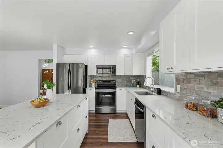 Check out the details!  Modern gourmet kitchen featuring stainless steel appliances, quartz counters, full height backspash and much more!