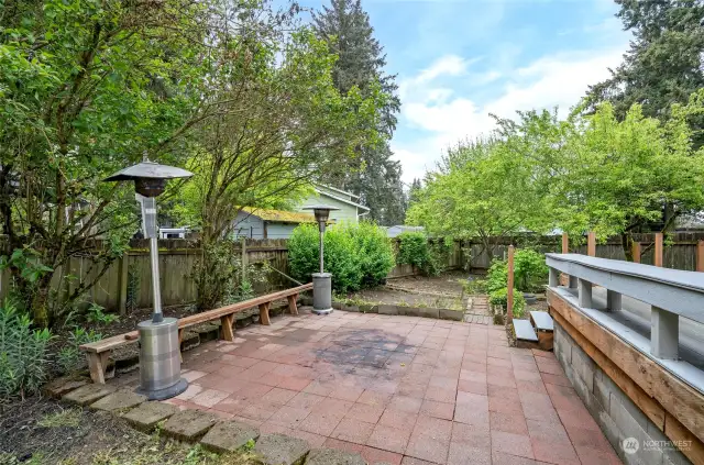 Fantastic backyard patio , perfect for a firepit. Mature apple, pear, and plum trees, not to mention the raspberries and strawberries, adorn the area just behind the patio."
