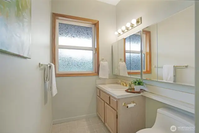 Conveniently located on the lower level, this full bathroom is perfect for guests or extended-stay living. Ideal for use alongside the adjacent game room or potential in-law suite.