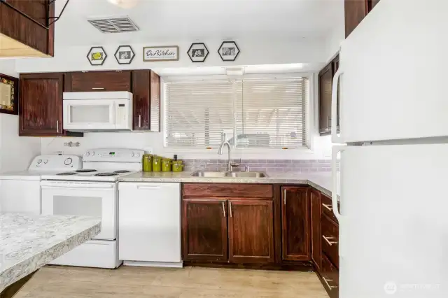 Such a lovely, bright kitchen!  All appliances are included.