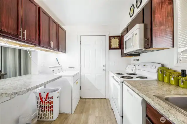 The pass-through on the left makes it easy to set dinner up buffet-style. The door leads to the back yard, patio, storage shed, and carport.
