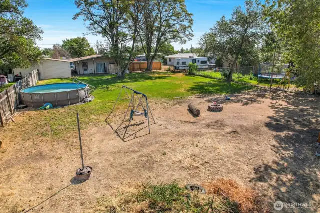 I love this photo! You see the pool, the home, the play area, the tetherball pole, and to the right, out of sight, is the wooden playset and chicken coop.
