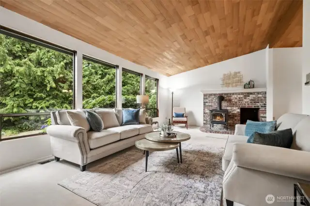 The bank of large windows lets the daylight shine in! Plus, those trees! This is PNW living at its best!