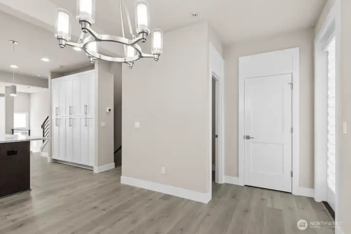 Powder bathroom and closet shown ahead to the right.