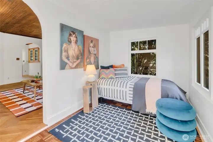The second bedroom is filled with windows.