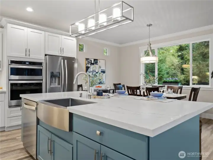 Stainless steel appliances, white quartz counter tops, white cabinets; very classic!