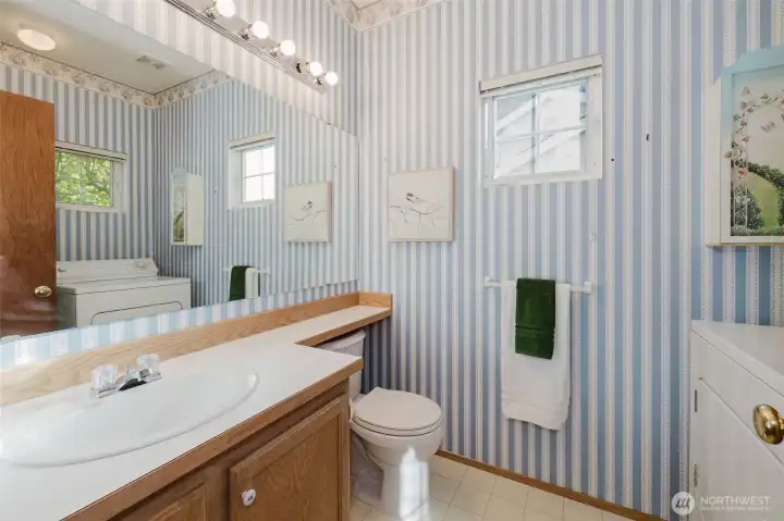 Half bath and laundry room combo on the first floor.
