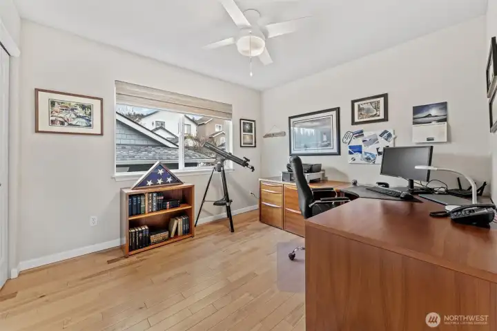 Bedroom Two offers a bright and versatile space, perfect for a home office, guest room, or creative retreat. A large window brings in ample natural light, while the ceiling fan adds year-round comfort.