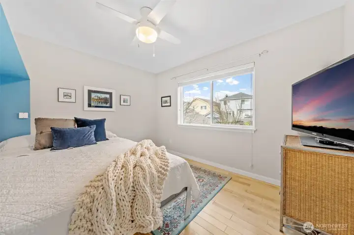 Bedroom Three offers a comfortable and adaptable layout, perfect for guests, hobbies, or additional living space. Soft natural light and a ceiling fan enhance comfort, while the clean design makes it easy to personalize.