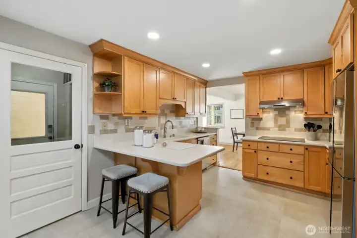Kitchen peninsula and doorway to breezeway to garage! Staircase #2 around the corner connects to bonus room!
