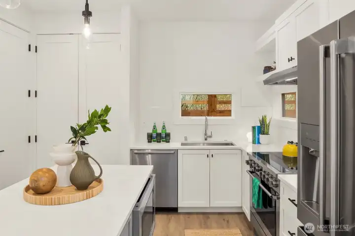 Enjoy a modern kitchen with induction range and high-end stainless steel appliances.