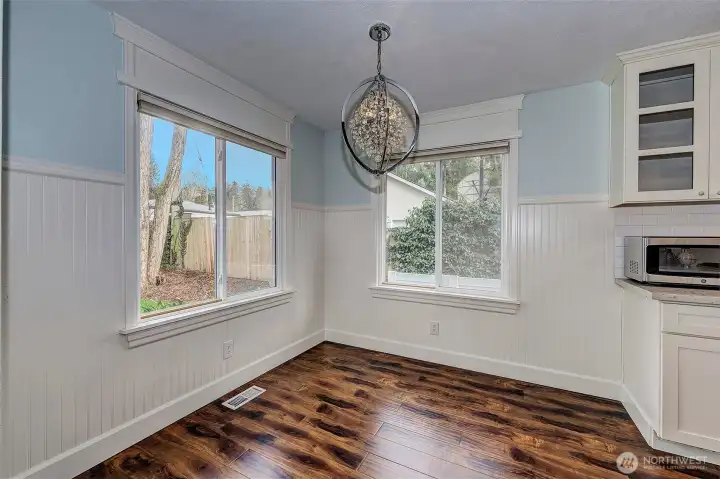 Dining room looks out to green grass and a private back patio. Open to the kitchen and living room to maximize opportunities for conversation.