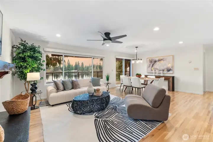 Open concept living room with expansive windows showcasing serene Echo Lake waterfront views