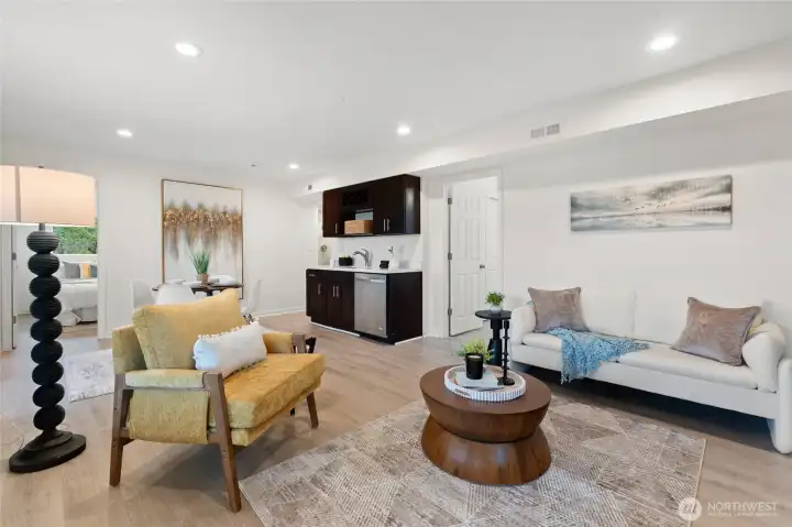 Open-concept lower level living space with kitchenette and flexible layout for entertaining or extended living