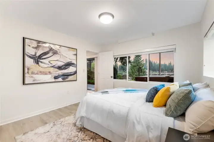 Comfortable bedroom with large window capturing peaceful Echo Lake views and natural surroundings