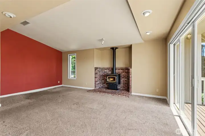 Family room with a wood standing fireplace.