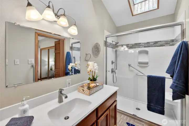 The primary bathroom has a large walk-in shower and plenty of counter space.
