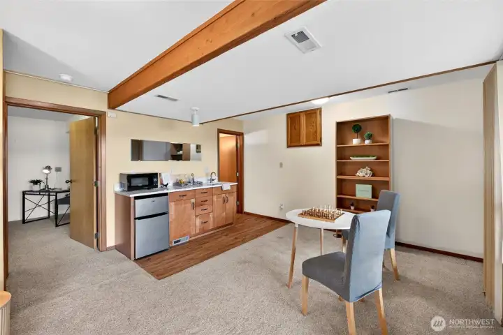 The downstairs has another finished room (possible office or 3rd bedroom), a bathroom, living area, and wet bar. Multi-generational living perhaps?
