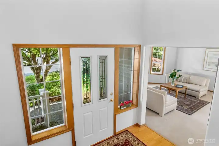 Welcoming vaulted, two story entry with warm wood flooring and sidelights to bring in natural light....so important in the PNW! Welcoming vaulted, two story entry with warm wood flooring and sidelights to bring in natural light....so important in the PNW!