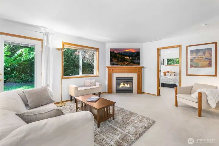 This living space has windows to the beautifully wooded rear yard, and a cozy gas fireplace with custom wood surround. This living space has windows to the beautifully wooded rear yard, and a cozy gas fireplace with custom wood surround.