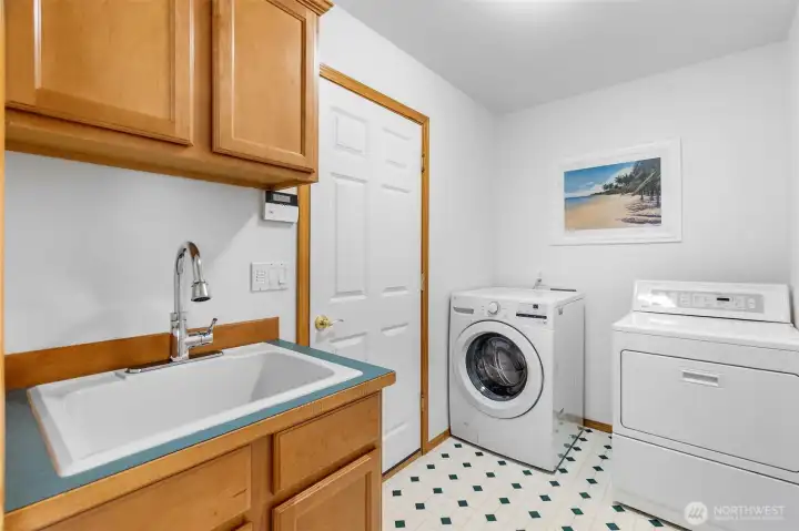 Main floor spacious laundry with utility sink and extra cabinetry. Another closet here adds even more storage. Gas dryer will convey. Main floor spacious laundry with utility sink and extra cabinetry. Another closet here adds even more storage. Gas dryer will convey.
