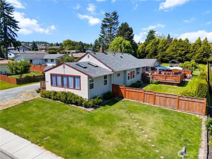 Spacious rambler on a beautifully maintained corner lot featuring expansive outdoor entertaining decks, a fully fenced yard, and plenty of room to relax, garden, and gather.