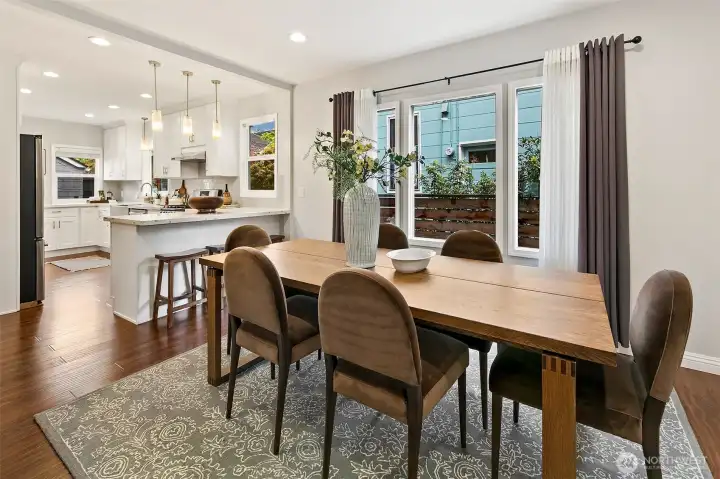 Living flows right into central dining area with open kitchen
