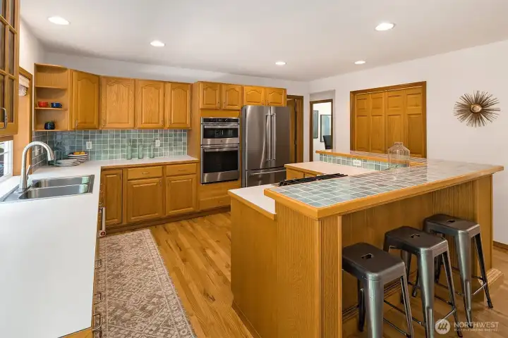 Breakfast counter and a nice-sized pantry behind the double doors at right. Breakfast counter and a nice-sized pantry behind the double doors at right.