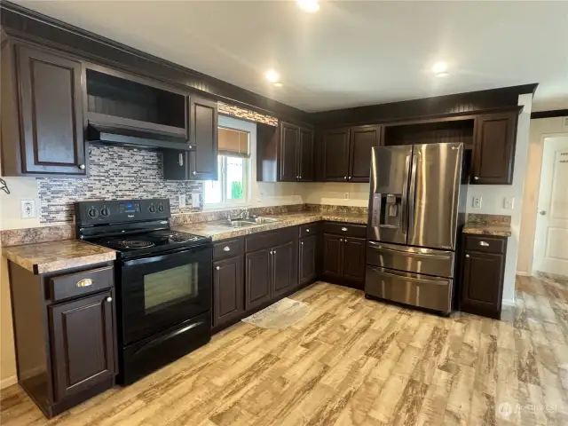 The kitchen is directly connected with the rest of the living area in this wonderful home.