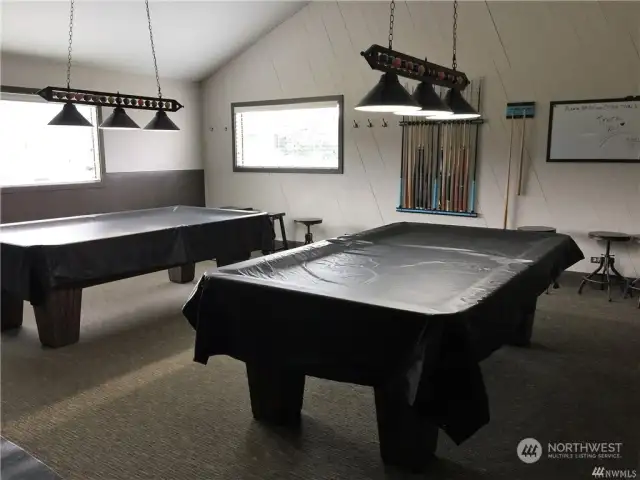 The game room at the clubhouse features two pool tables.