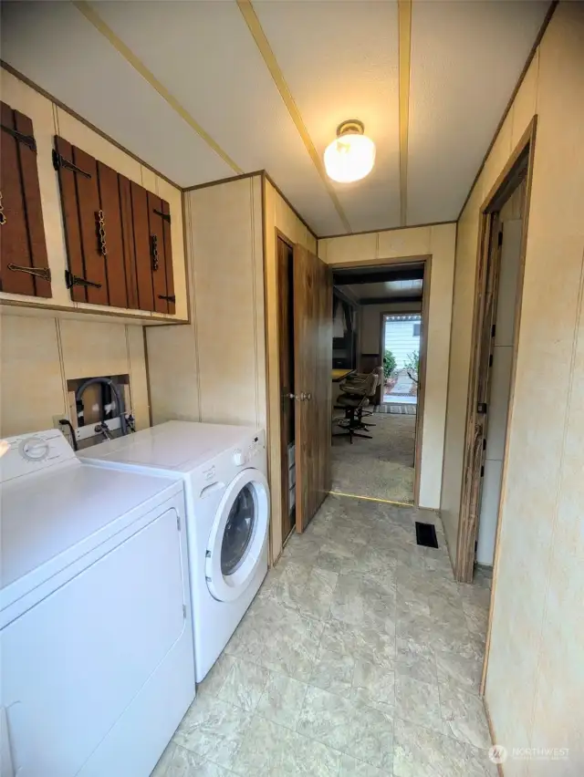 Large laundry area with cabinets