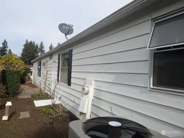 West side of home showing small patio at laundry door