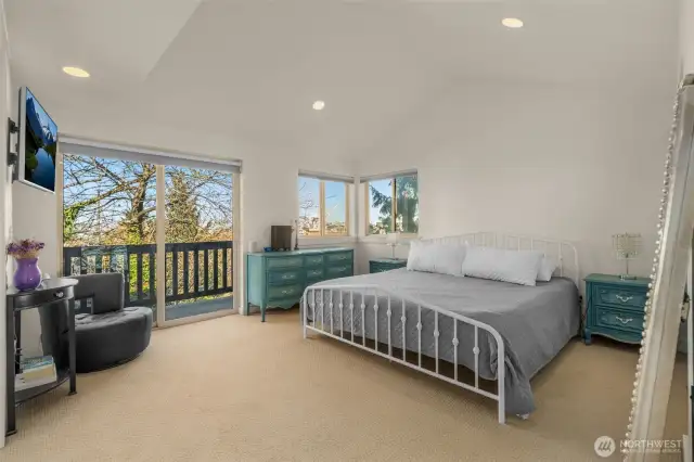 Primary bedroom with vaulted ceilings.