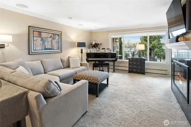 Living room has a wood burning fireplace and w/w carpet.