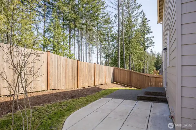 Fully-fenced back yard with patio