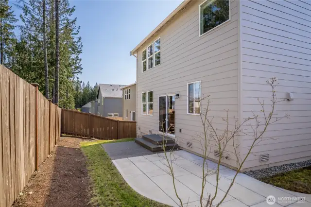 Fully-fenced back yard with patio