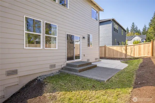 Fully-fenced back yard with patio