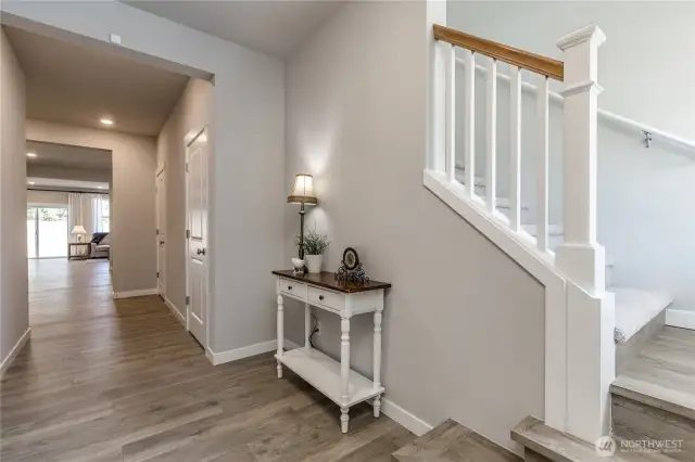 Elegant front entry with custom stairs. Oversized storage closets here, too!