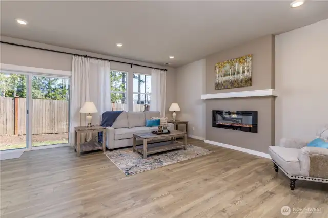 Large living room features a sleek, modern fireplace