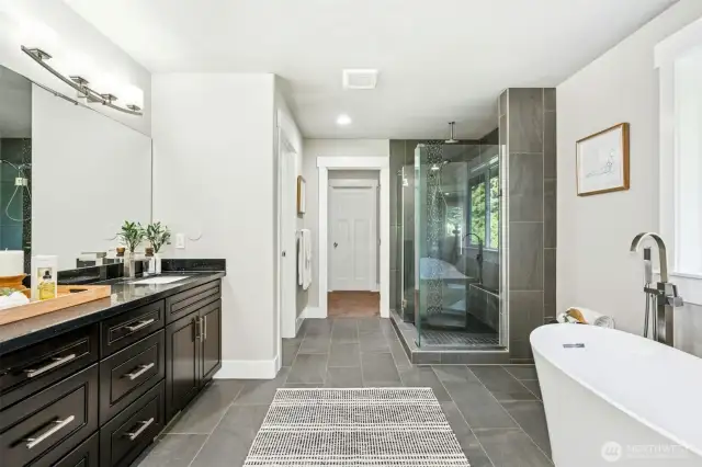 Dual vanities, standalone tub & glass wall shower