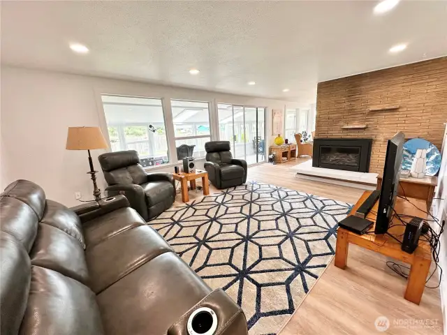 Comfy Living Room with fireplace looking out into sunroom