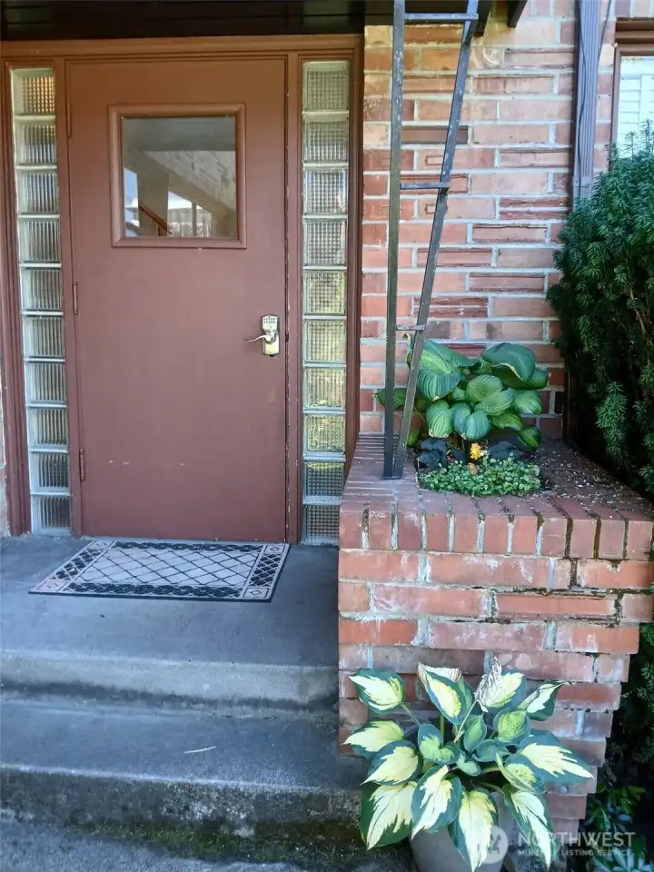 Secured exterior door that welcomes you to the entry and unit door.