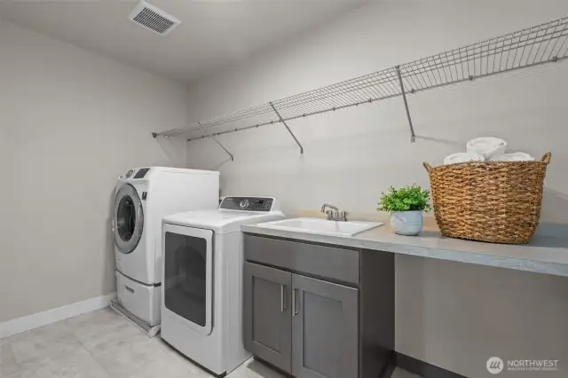 Upstairs laundry room with utility sink