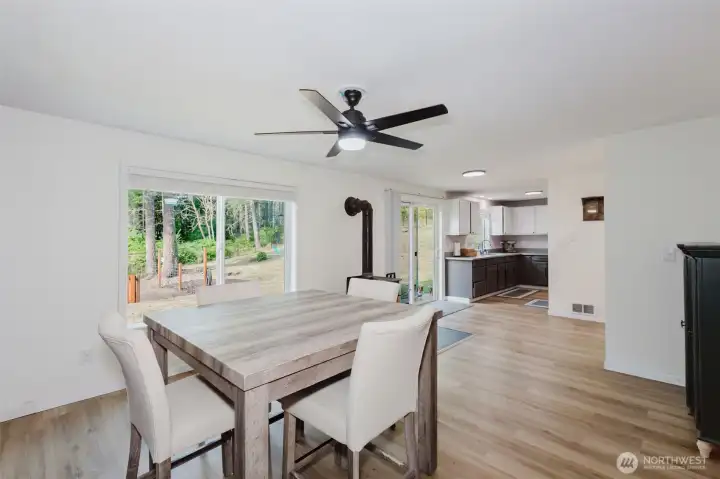 Dining area with laminate floors and ceiling fan.