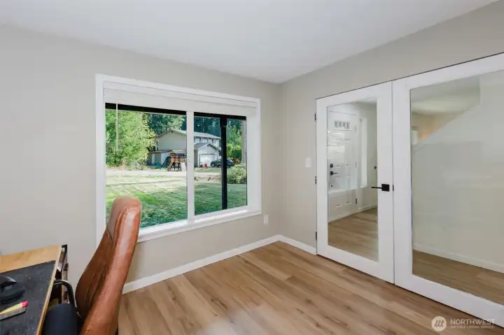 Additional bedroom with laminate floors and large window.