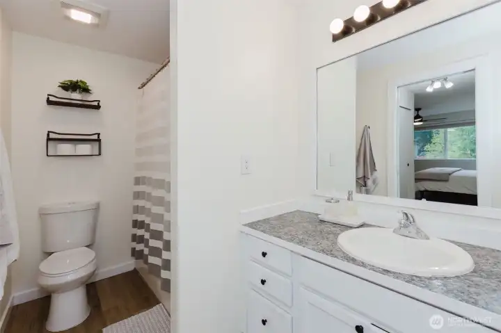 Guest bath with bright vanity and laminate counters.