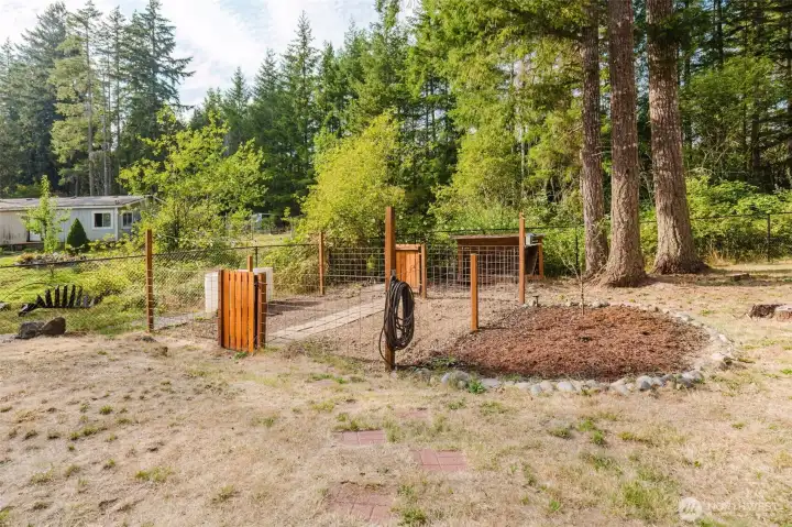 Backyard fire pit and sitting area for outdoor enjoyment.