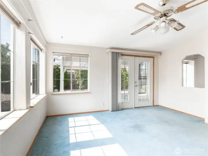 Light Filled Family Room with French Doors Leading Out to the Covered Patio.
