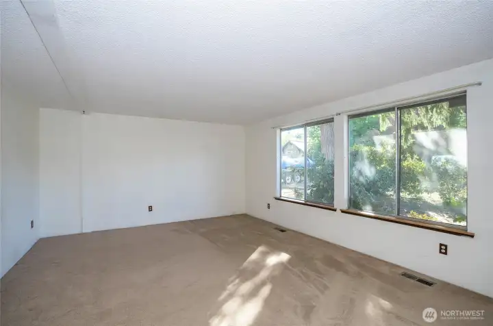 Spacious living area with oversized picture windows—enjoy the feeling of nature flowing indoors.